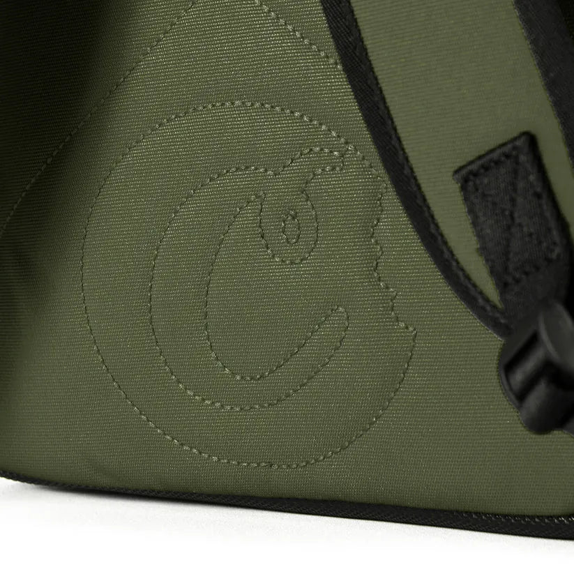 Embossed "Cookies" logo on a green smell-proof backpack made of durable fabric.