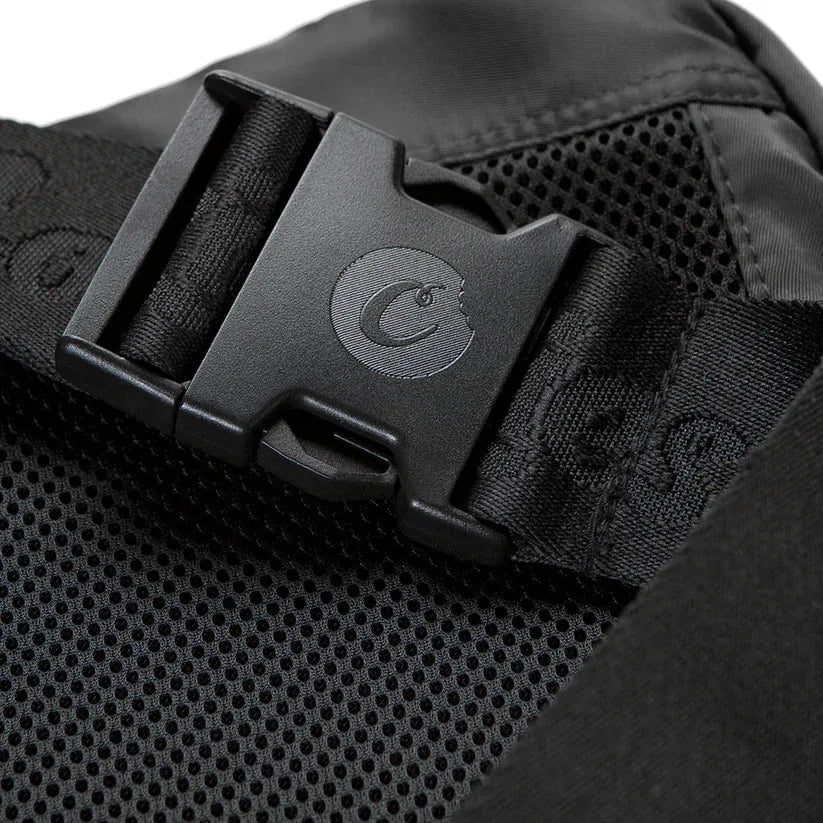 Black nylon traveler smell proof sling bag with a black buckle featuring a circular logo
